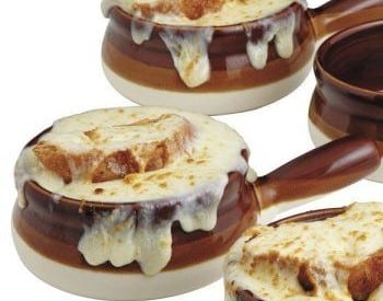 brown soup crocks with handles with cheese dripping down the sides and cheese with bread overflowing the top