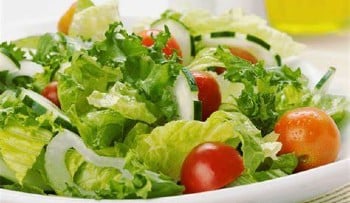 lettuce in a bowl with onion, cucumber & tomatoes