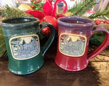 Green and burgundy ceramic mugs with a beige medallion of the front of the Sheridan House Inn