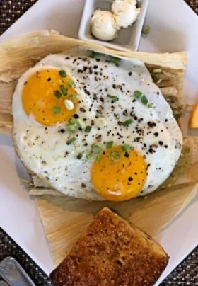 Sunny side eggs on top of tamales with cornbread