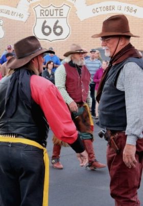 three cowboys in wild west playacting